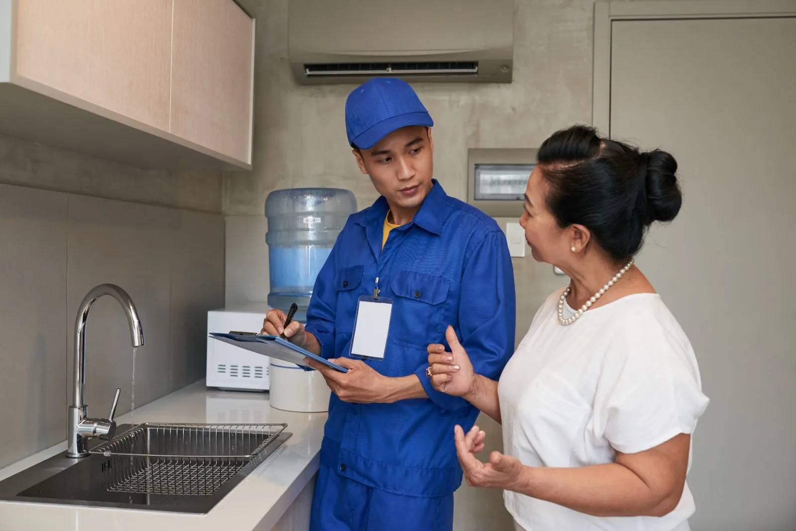 plumber technician talking to customer