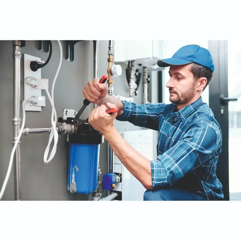 technician fixing water filter housing